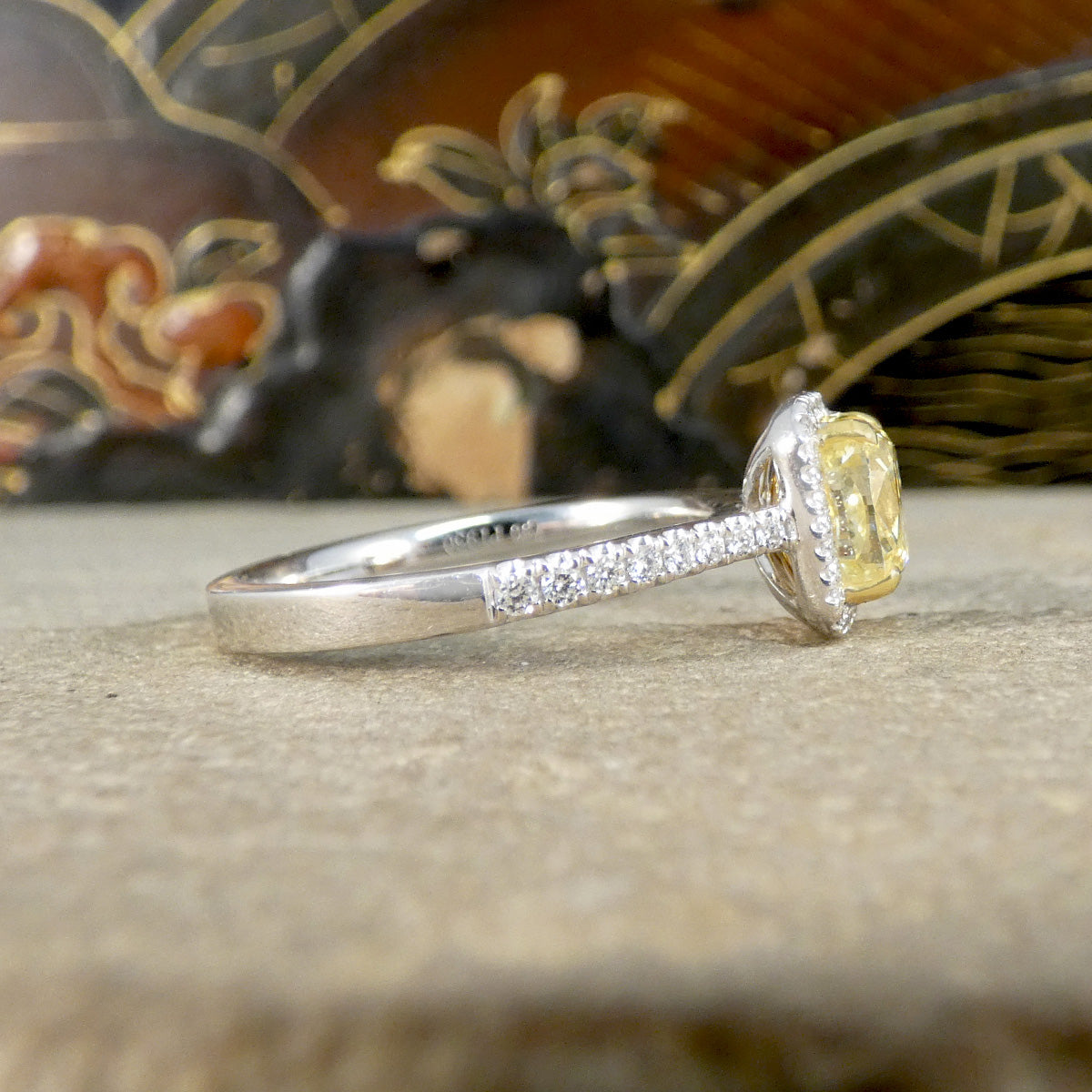 Side view of Diamond engagement ring featuring a yellow cushion cut diamond.