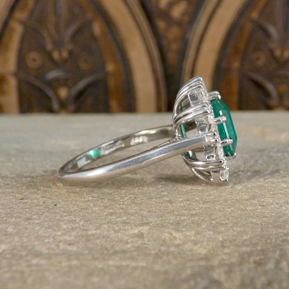 Side view of Emerald and Diamond cluster ring showing plain polished 18ct White Gold band.