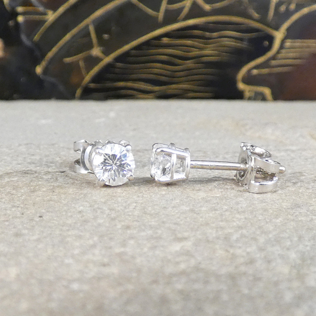 0.61ct Diamond Stud Earrings GIA Certified in 18ct White Gold shown from the front and side to see open setting allowing light to dance through the diamond.