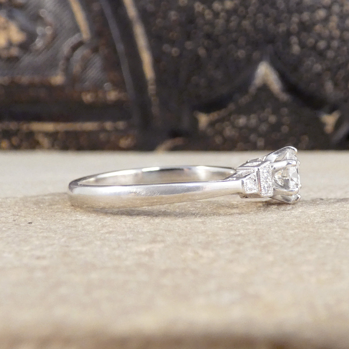 Side view of Diamond engagement ring in Platinum showing plain polished band.