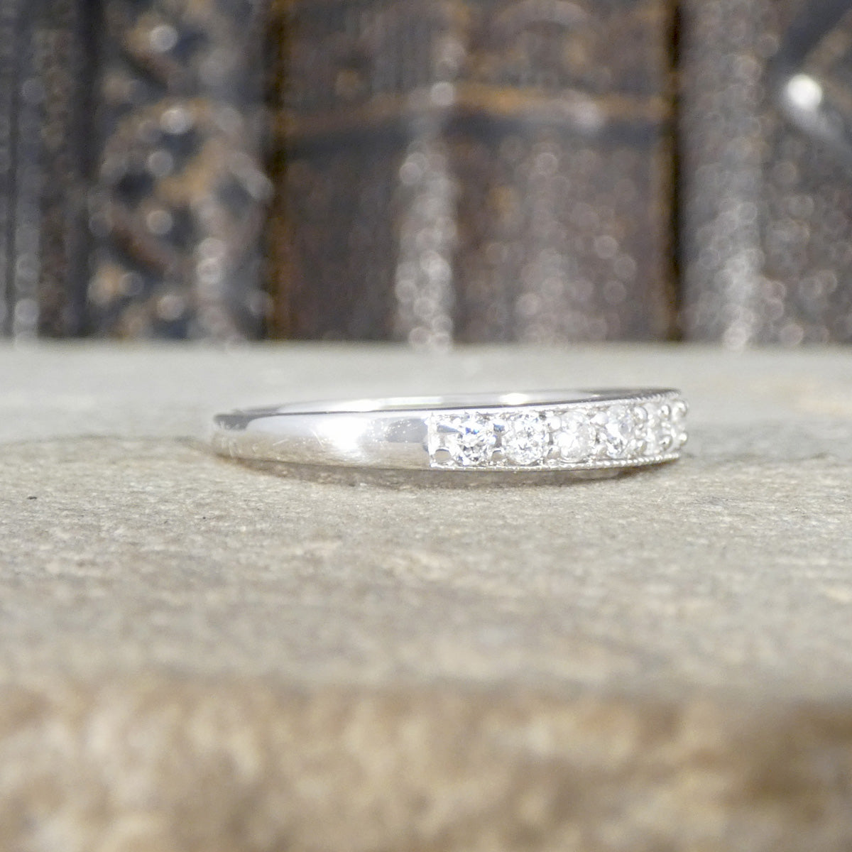 Diamond half eternity ring in 9ct white gold shown from the ide.