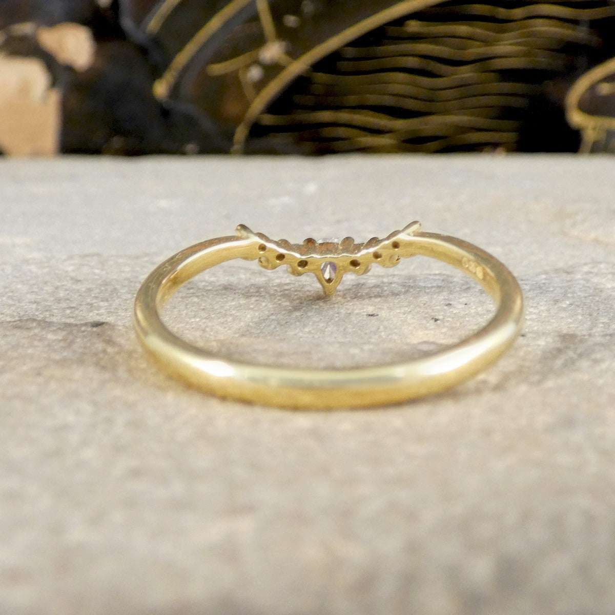 Gold ring with small stones on a textured surface