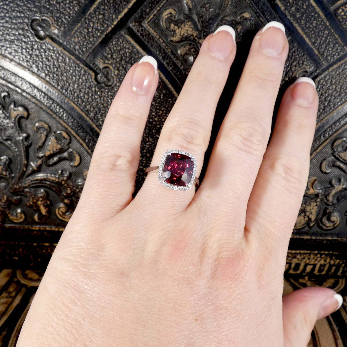 Rhodolite Garnet and Diamond Cluster Ring in 18ct White Gold displayed on the hand showing size ratio and the burst of colour.