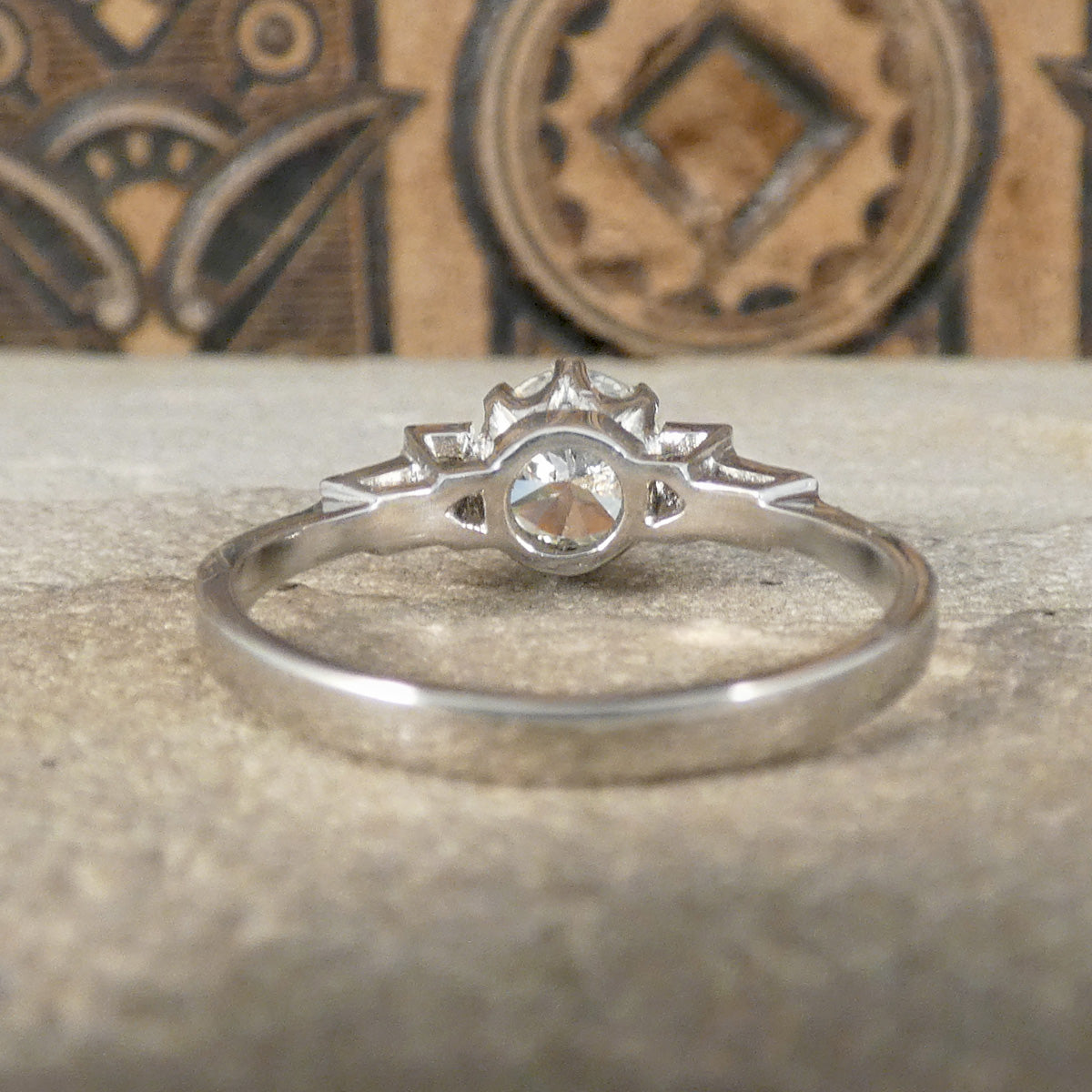 Back view of Diamond engagement ring with an early brilliant cut centre and baguette cut diamond shoulders set in Platinum. Showing open setting.