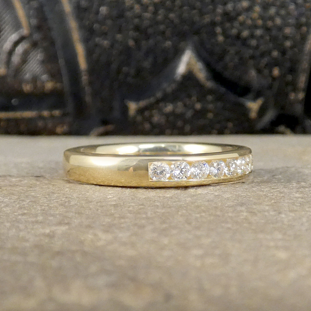 Channel Set Brilliant Cut Diamond Half Eternity Ring modelled in 9ct yellow gold for durability. Side view showing how for it goes around the finger.