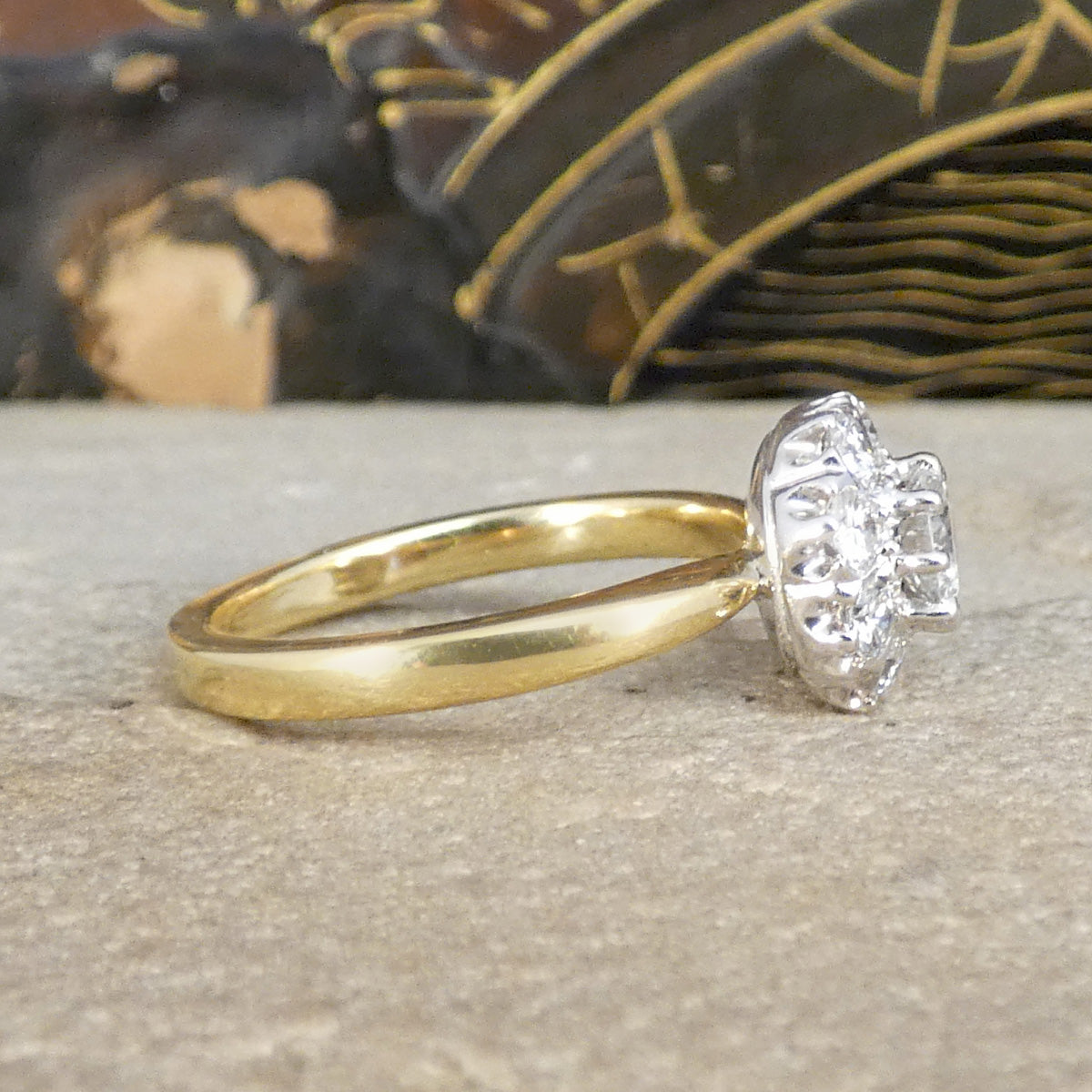 Side view of bright and sparkly vintage early brilliant cut diamond cluster ring in 18ct White Gold with a 18ct Yellow Gold band with slightly tapered shoulders and a domed band.