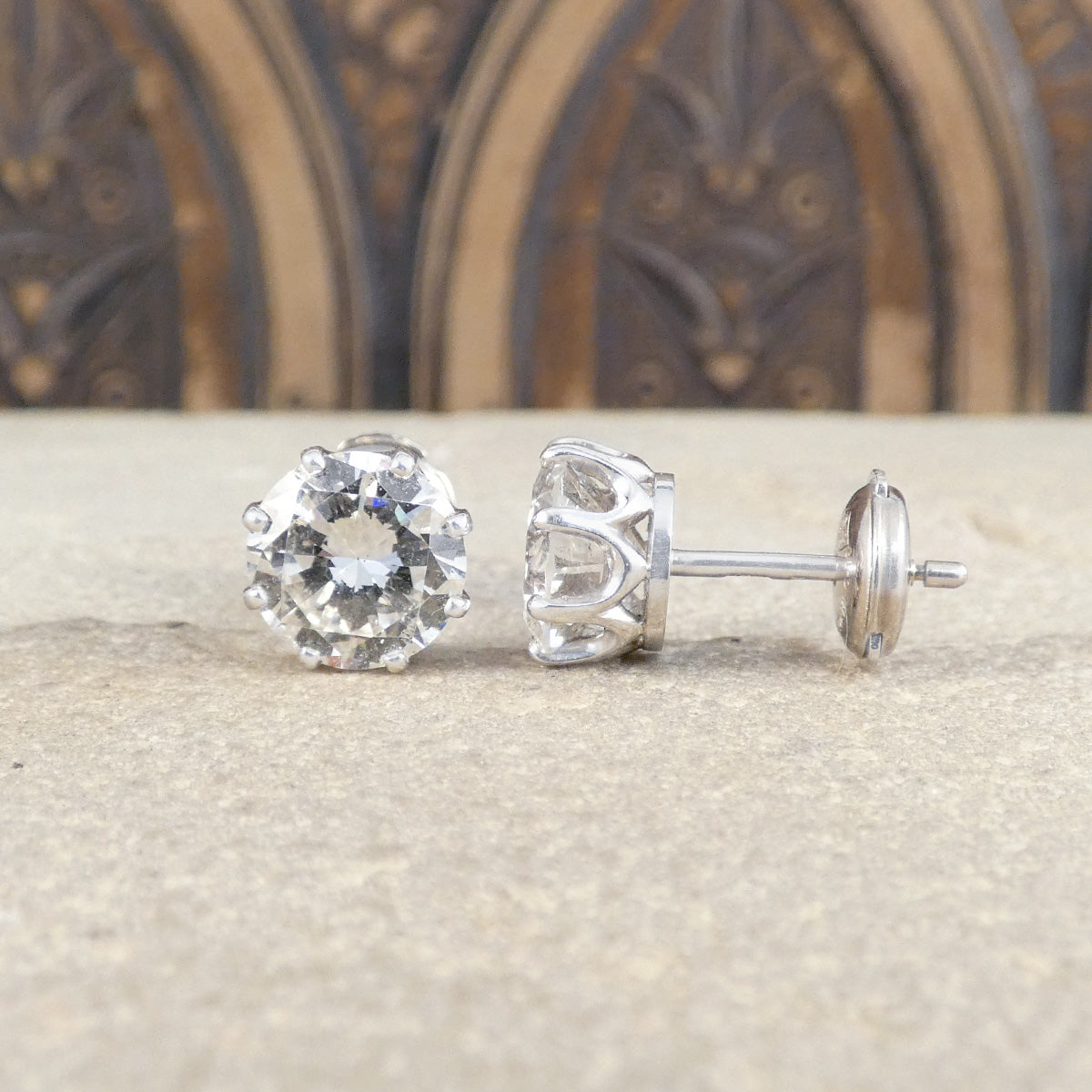 Side and front view of large Diamond stud earrings set with an alpha back for extra safety.