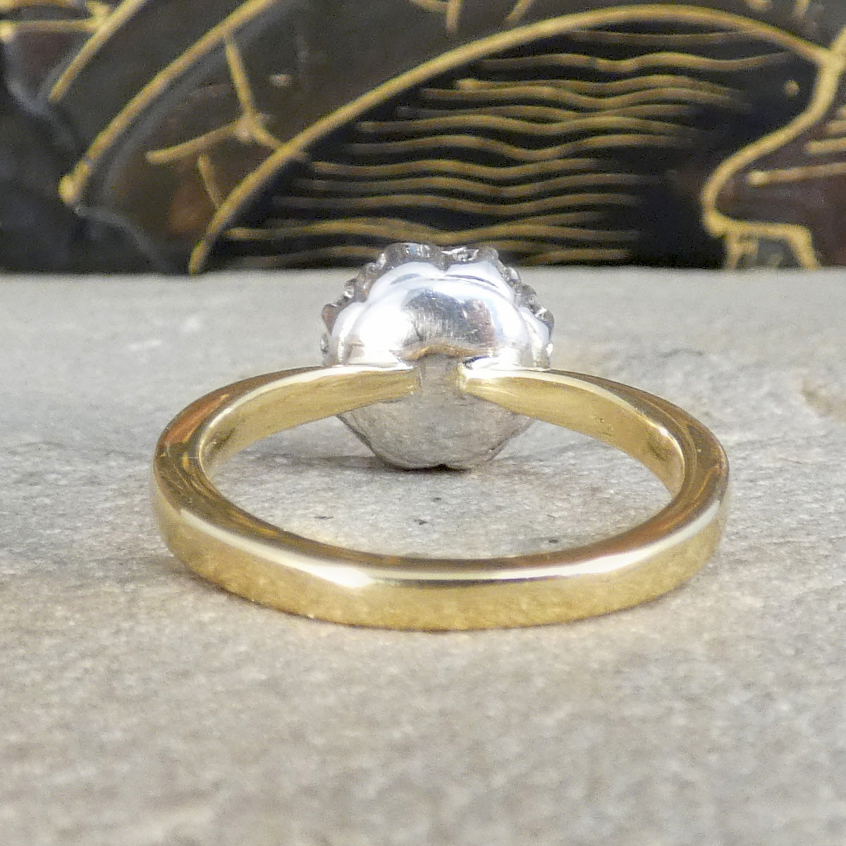 Back view of Diamond cluster ring with a closed band in white gold and domed band in yellow band.