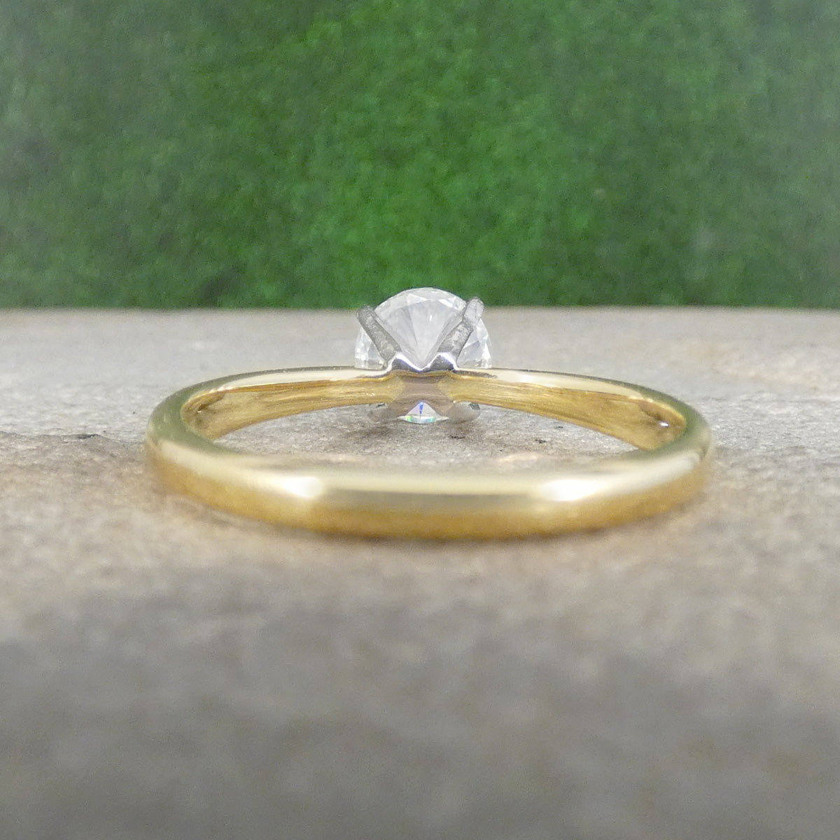 Classic Brilliant Cut Diamond Solitaire Engagement Ring in 18ct Gold showing open setting allowing light to pass through.