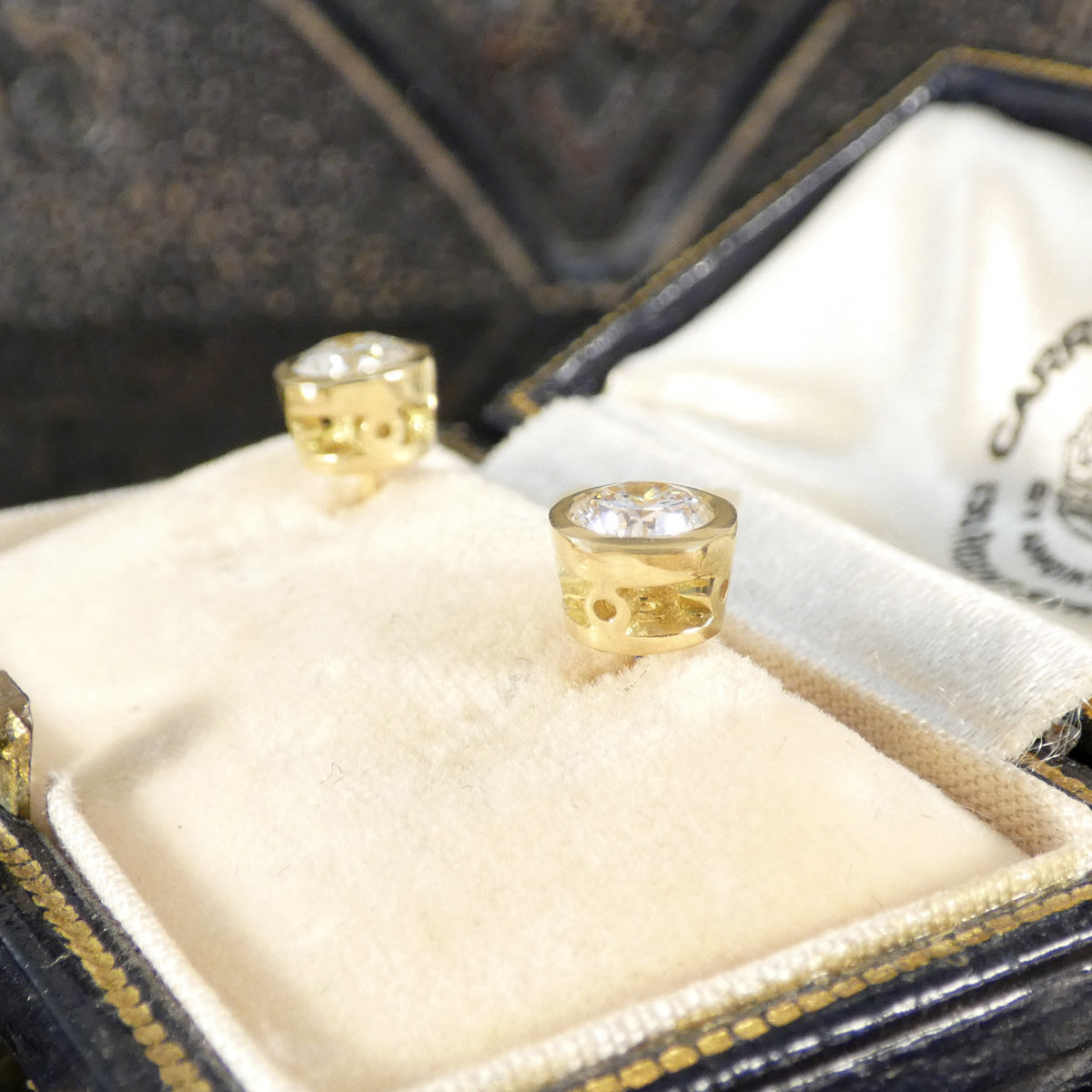 Side profile of Diamond stud earrings, showing the detail in the settings in 18ct yellow gold.