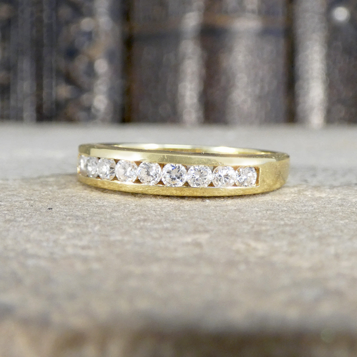 Gold ring with diamonds on a textured surface