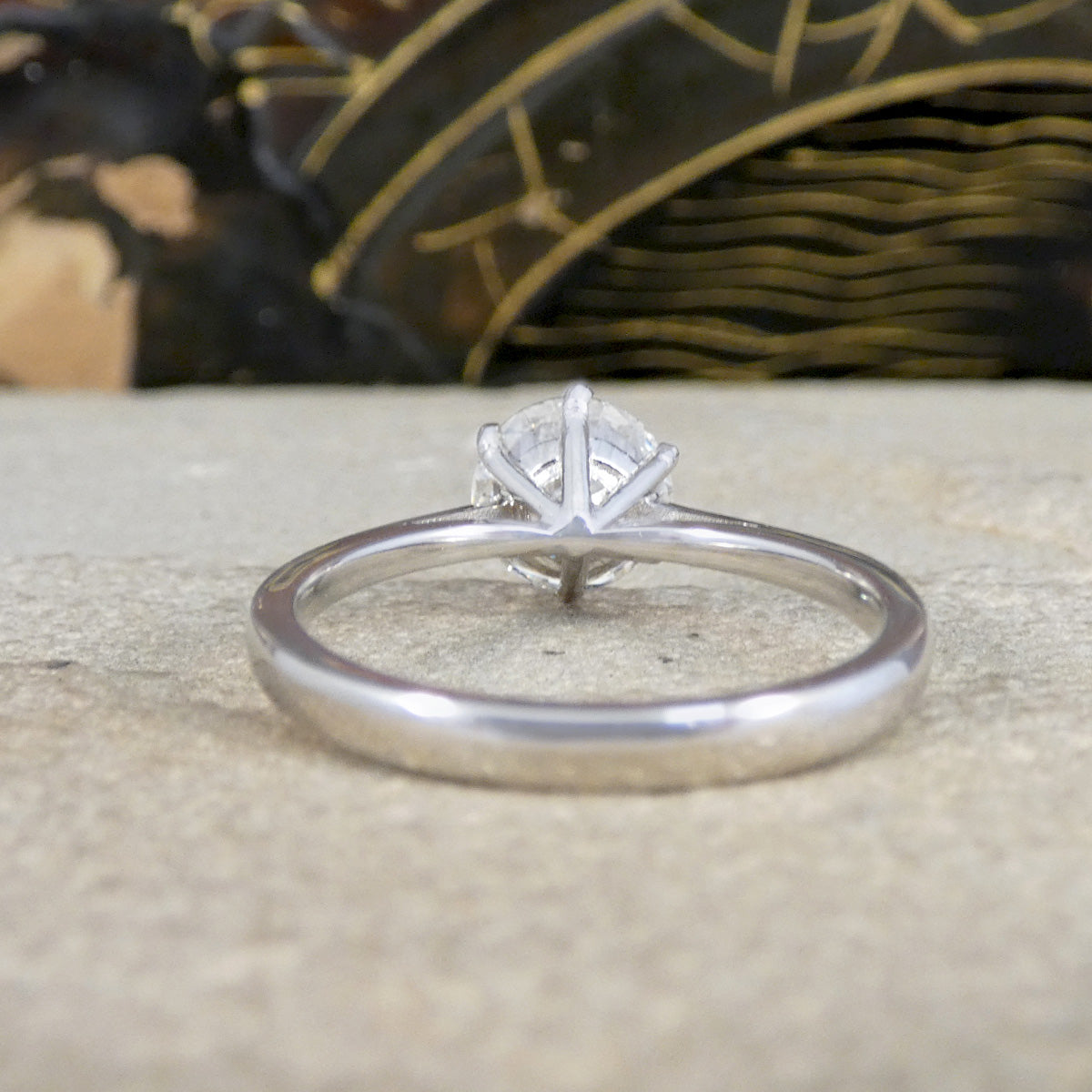 Back view of Diamond solitaire engagement ring with a platinum plain polished band.
