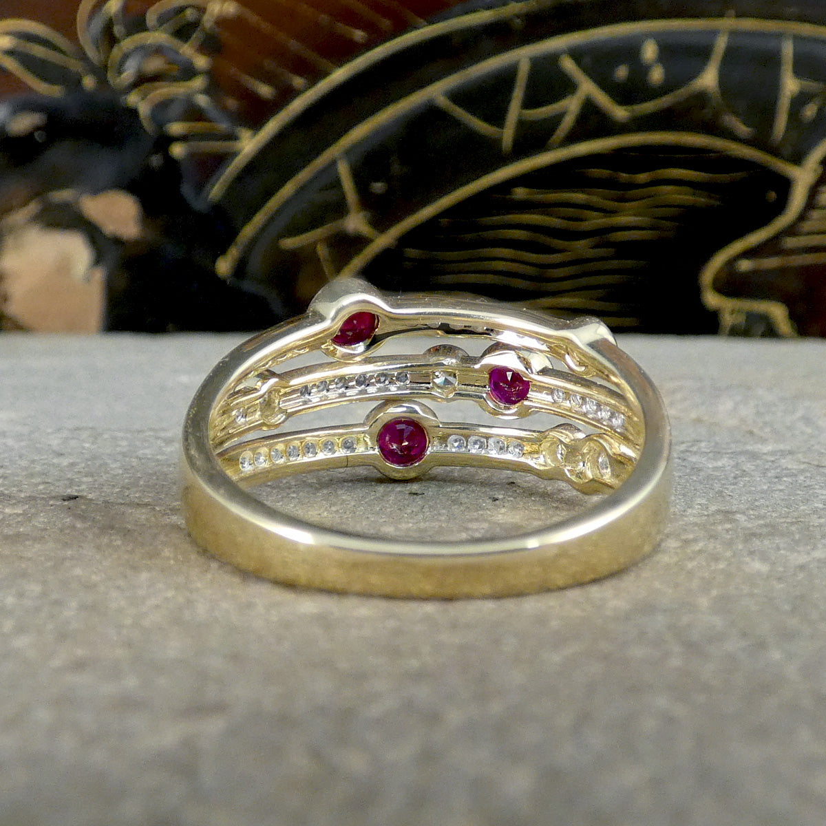 Back view of Ruby and Diamond bubble ring, showing the open setting and how the band graduates down in size towards the back of the ring.