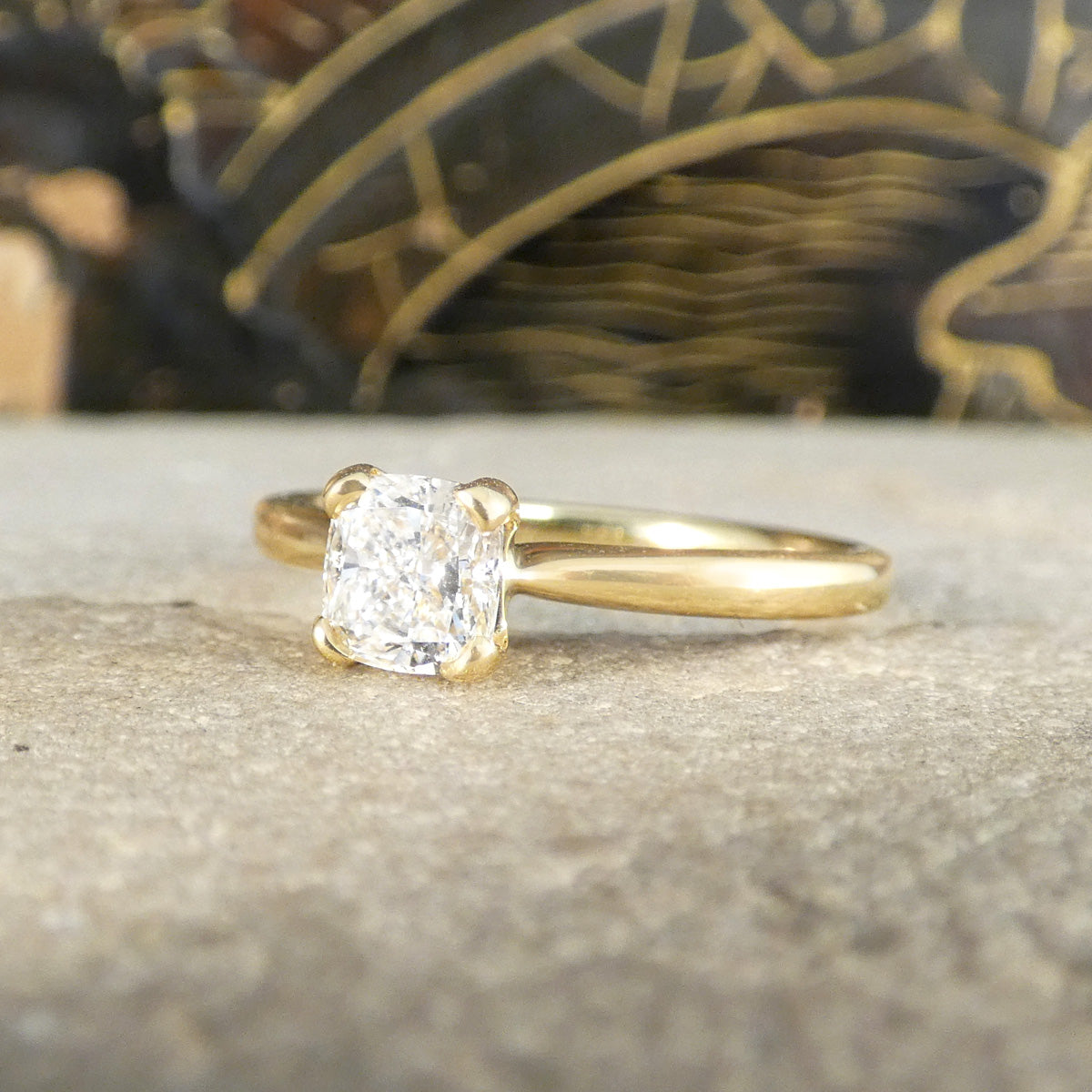 8-carat yellow gold solitaire ring featuring a bright and sparkly GIA-certified modified cushion-cut diamond of E colour. The radiant diamond catches the light beautifully, complementing the polished gold band for a luxurious and timeless appearance.