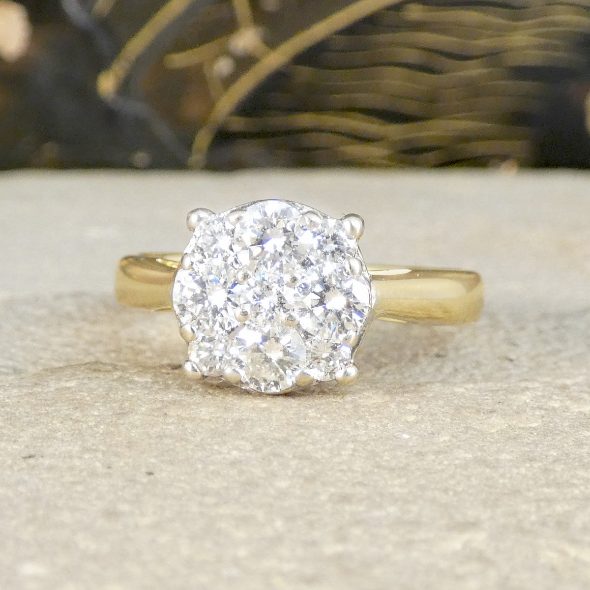 Gold ring with a large diamond on a textured surface