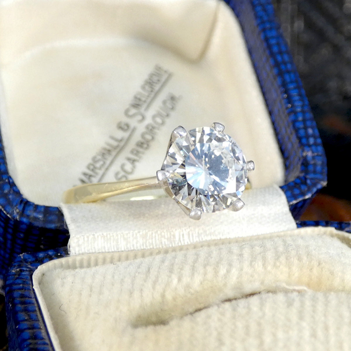 A gorgeous bright and clear diamond solitaire ring set in a size claw setting in a vintage box.