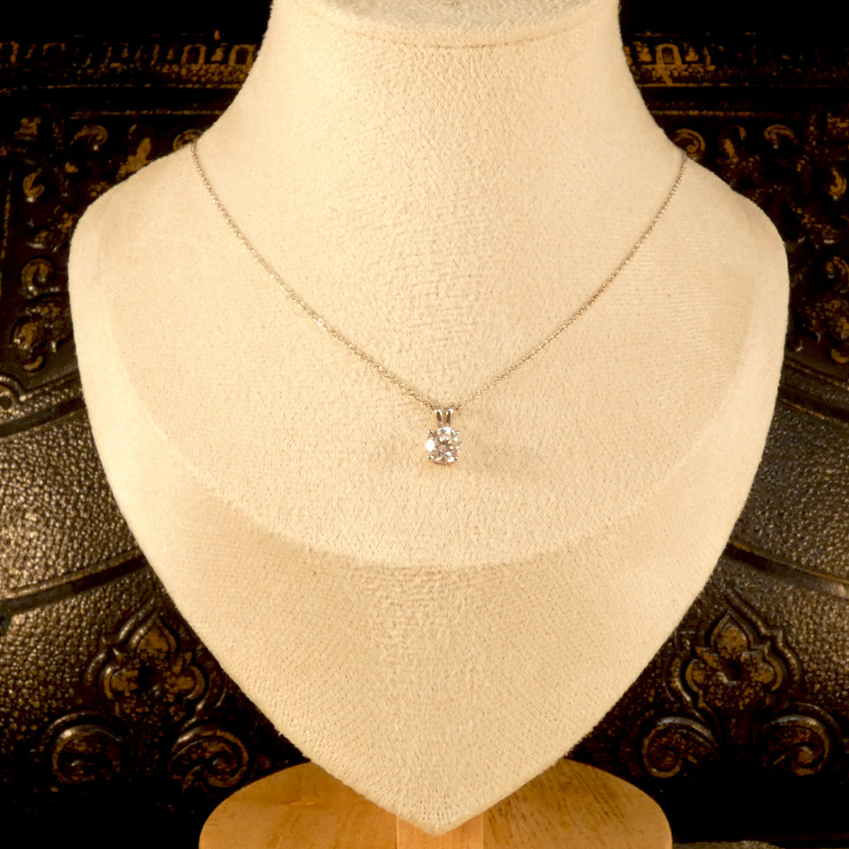 Diamond Solitaire pendant necklace in 18ct white gold on an 18ct white gold trace chain. The perfect sparkly gift featuring a bright and sparkly 0.71ct round brilliant cut diamond. Shown on bust for size reference.