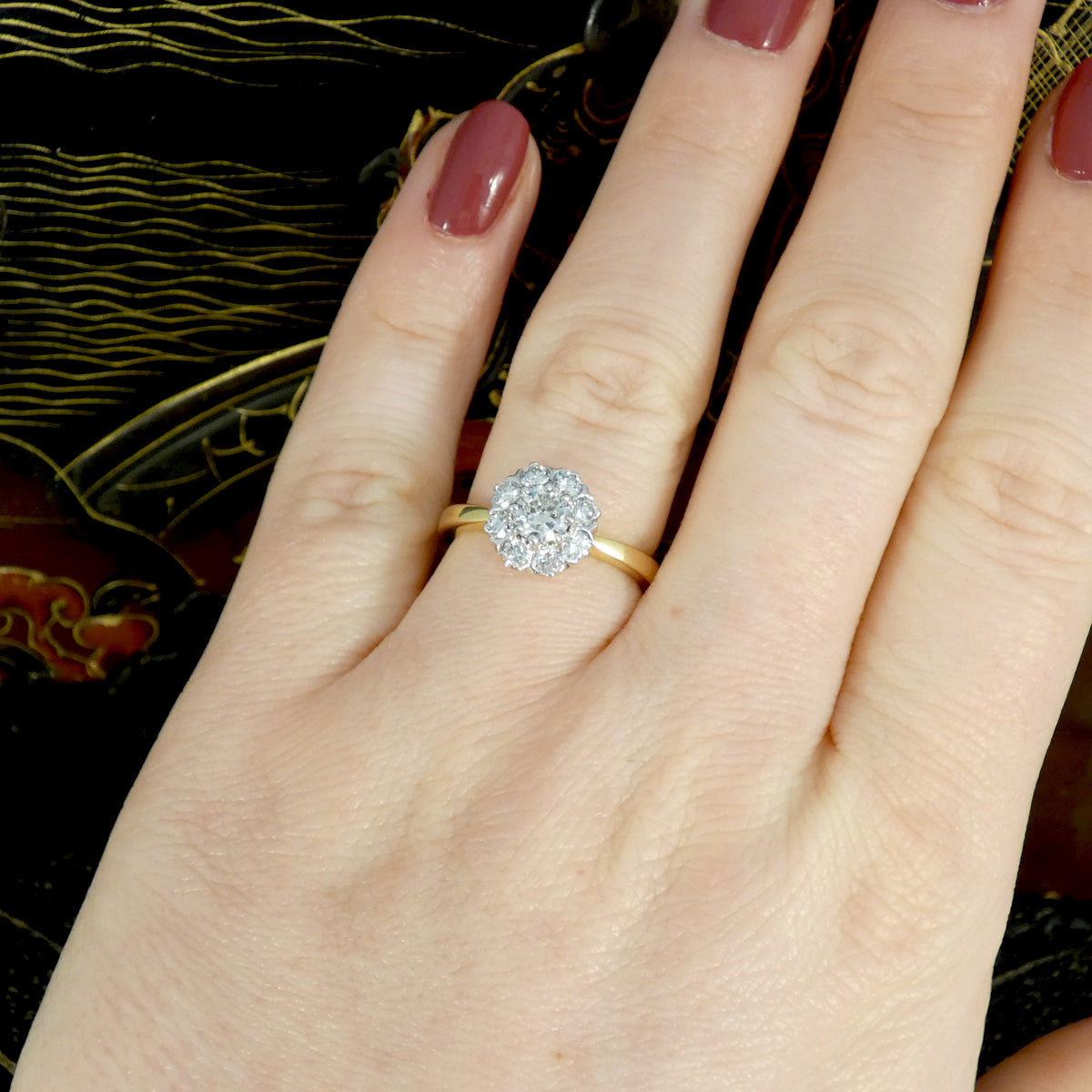 Bright and sparkly vintage early brilliant cut diamond cluster ring in 18ct White Gold with a 18ct Yellow Gold band with slightly tapered shoulders. Holding 0.90ct diamonds and shown on the finger for size and shape reference.