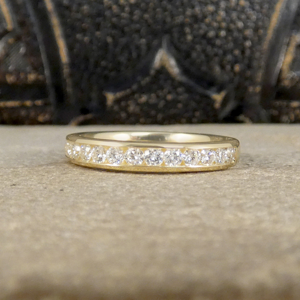 Channel Set 0.54ct Brilliant Cut Diamond Half Eternity Ring modelled in 9ct yellow gold for durability.