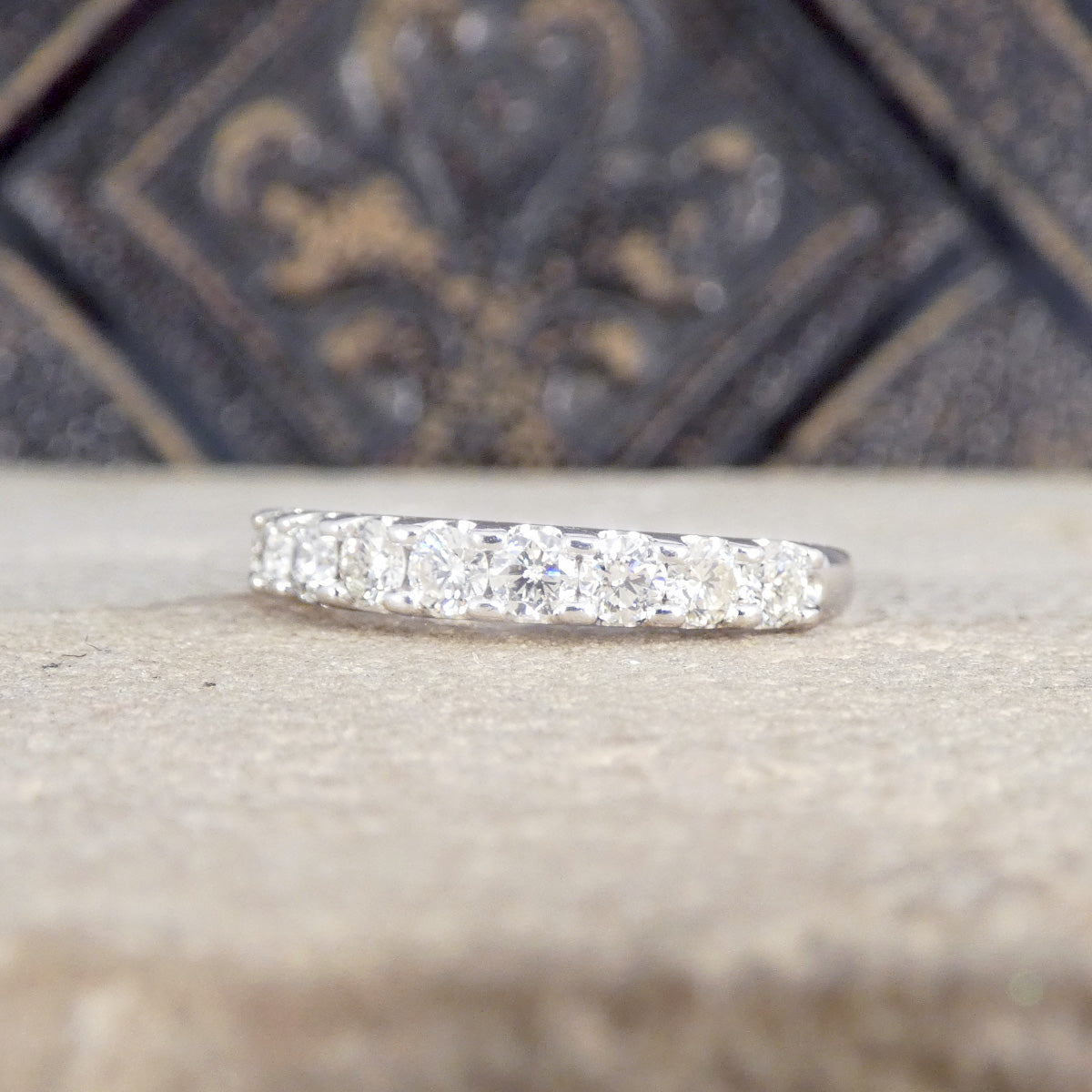 9ct white gold half eternity ring with shared claw setting.