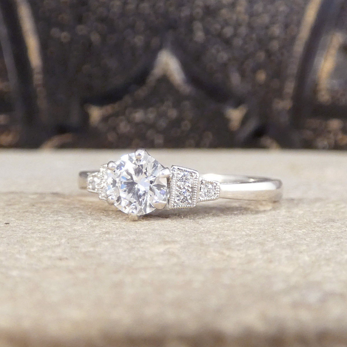 Clear view of quality diamond engagement ring with diamond set shoulders in platinum.
