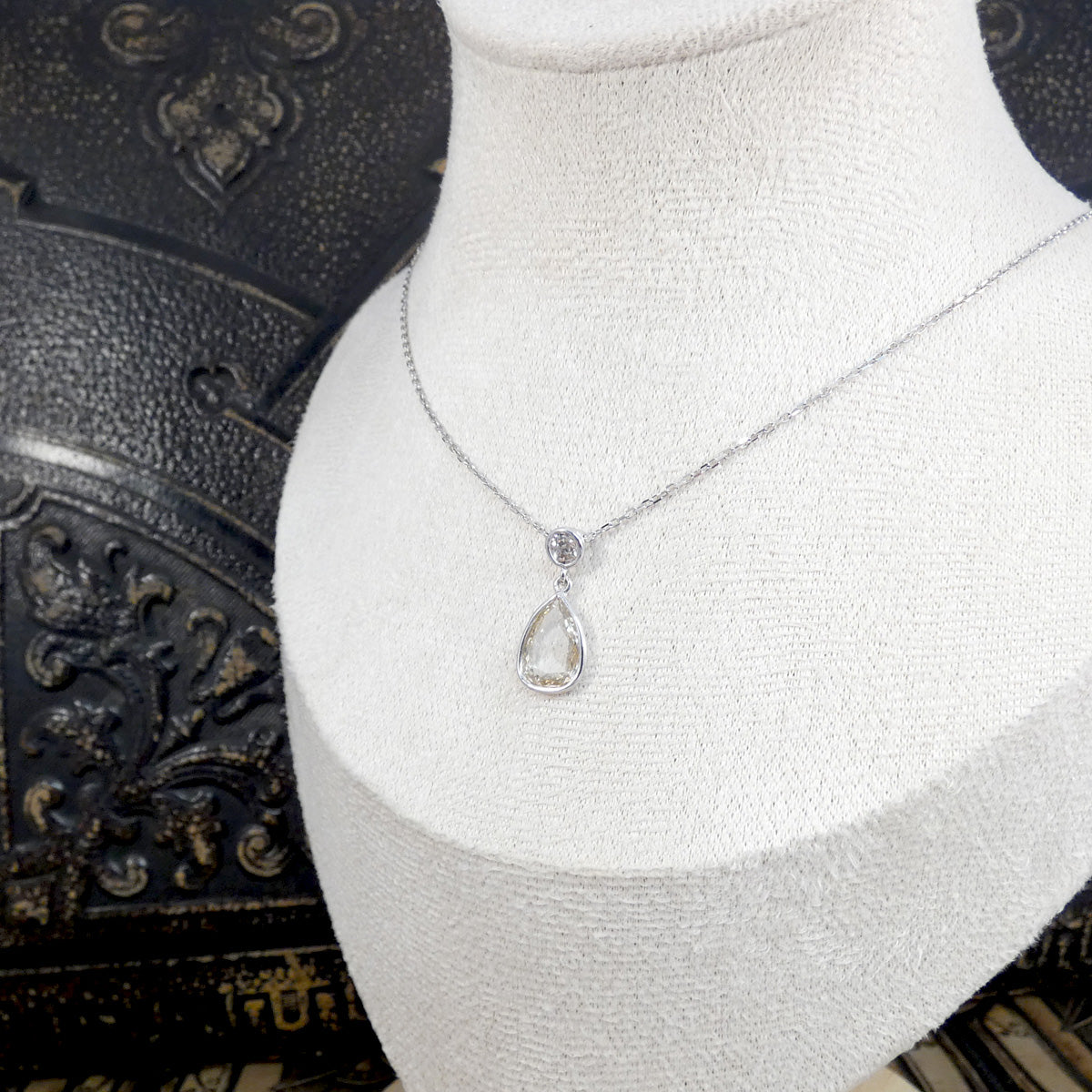 Unique modified rose cut Diamond and brilliant cut drop necklace in 18ct White Gold. Displayed on a bust to see how it sits on a neckline.
