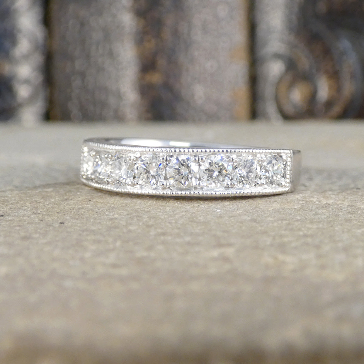 Diamond ring on a textured surface with a blurred background