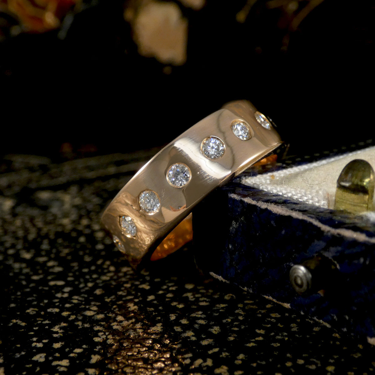 Wide band showing a full diamond set band in 18ct rose gold.