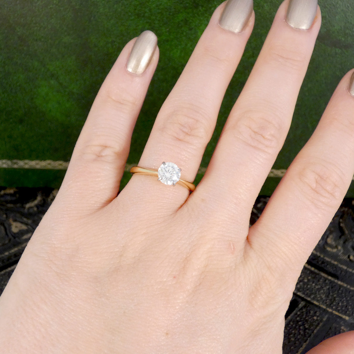 Aclassic four claw diamond solitaire engagement ring in 18ct yellow gold.