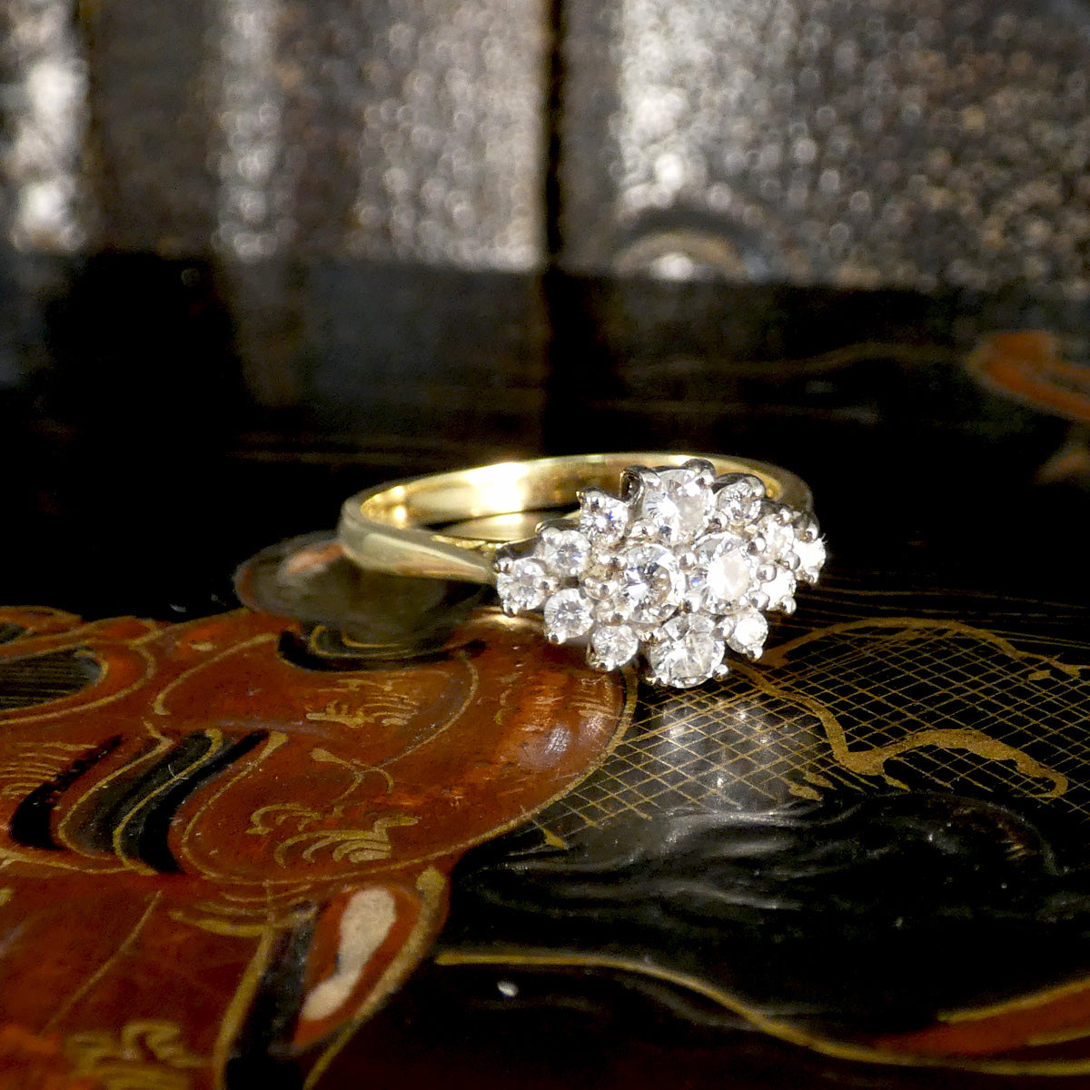 Gold ring with diamonds on a decorative surface