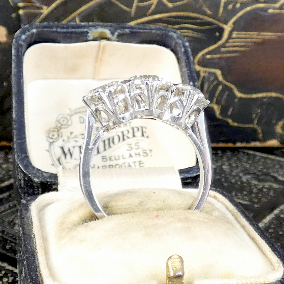 3.88ct Diamond Three Stone Trilogy Ring in Platinum shown from the side to see full gallery setting and the beautiful detail.