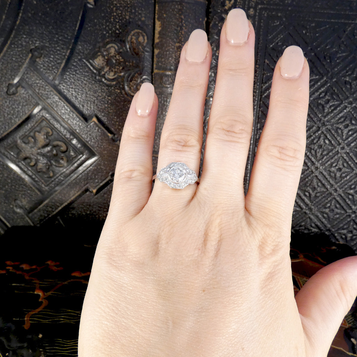 A gorgeous Art Deco inspired Diamond cluster ring in Platinum displayed on the hand to see how it would look when worn.