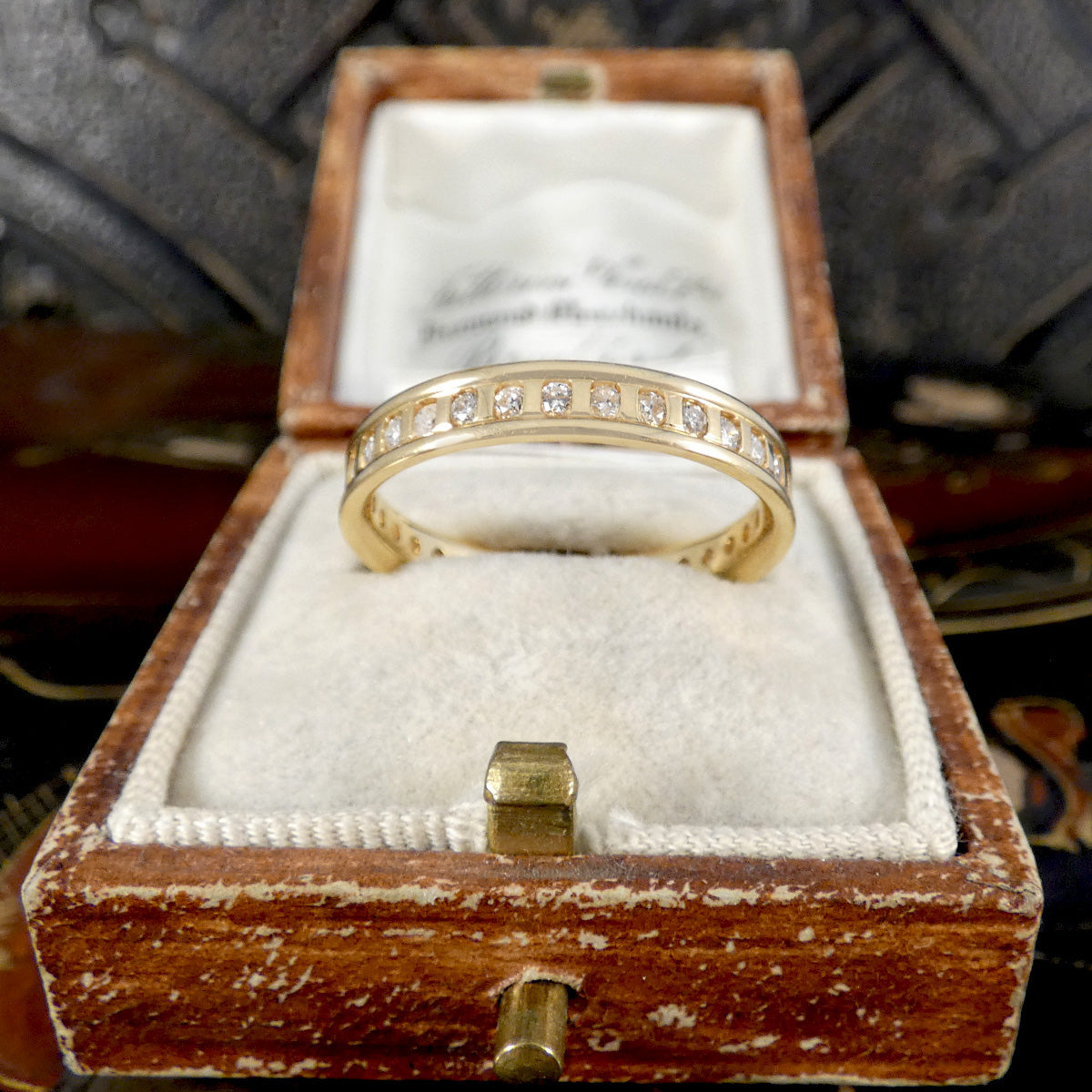 Gold ring with diamonds in a vintage wooden box