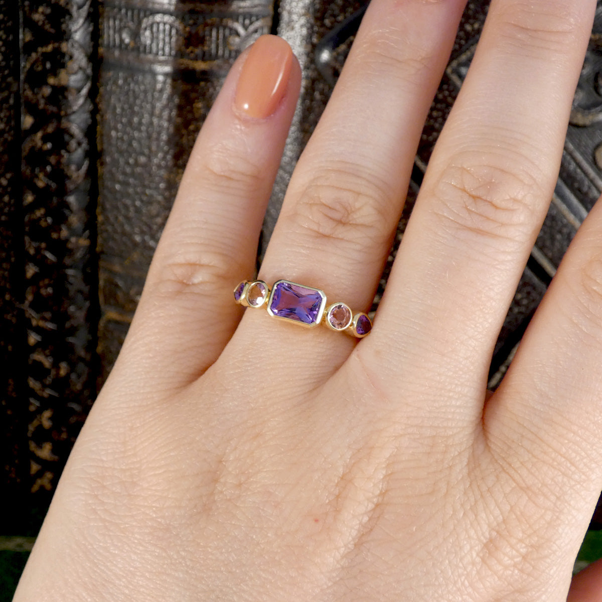 A gorgeous bright and beautiful Amethyst and Pink Tourmaline five stone ring in 9ct yellow gold with bezel settings. Shown on the ring finger to see size and shape reference.