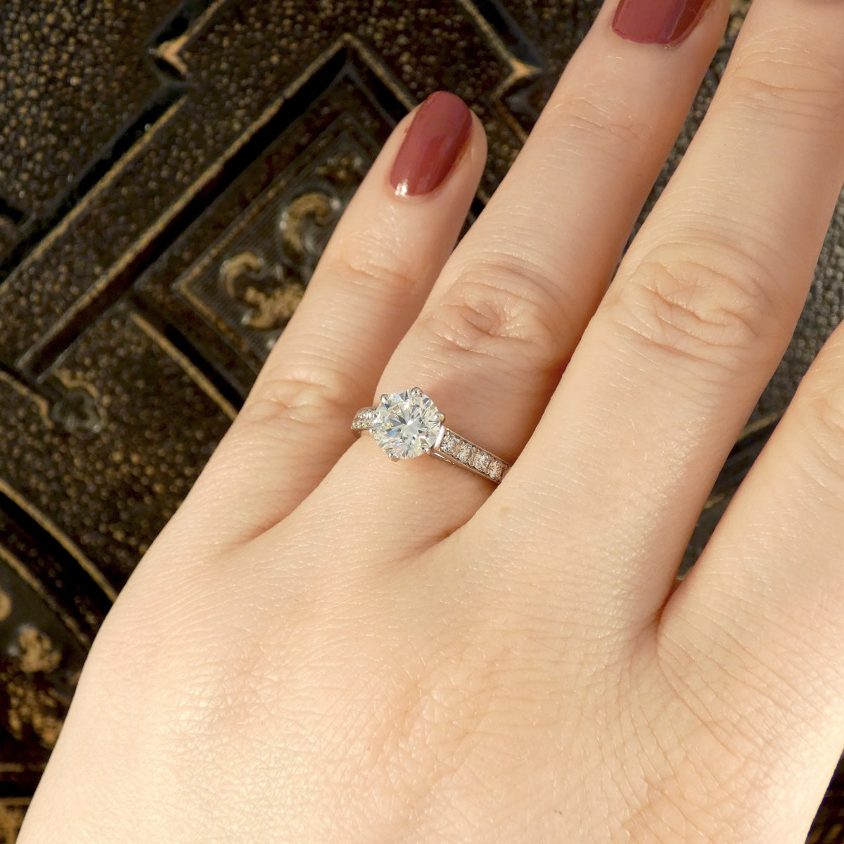 1.30ct Diamond Solitaire with 0.56ct Diamond Set Shoulders in Platinum shown on finger for size and shape reference. High clarity and and near colourless grading, the perfect engagement ring.