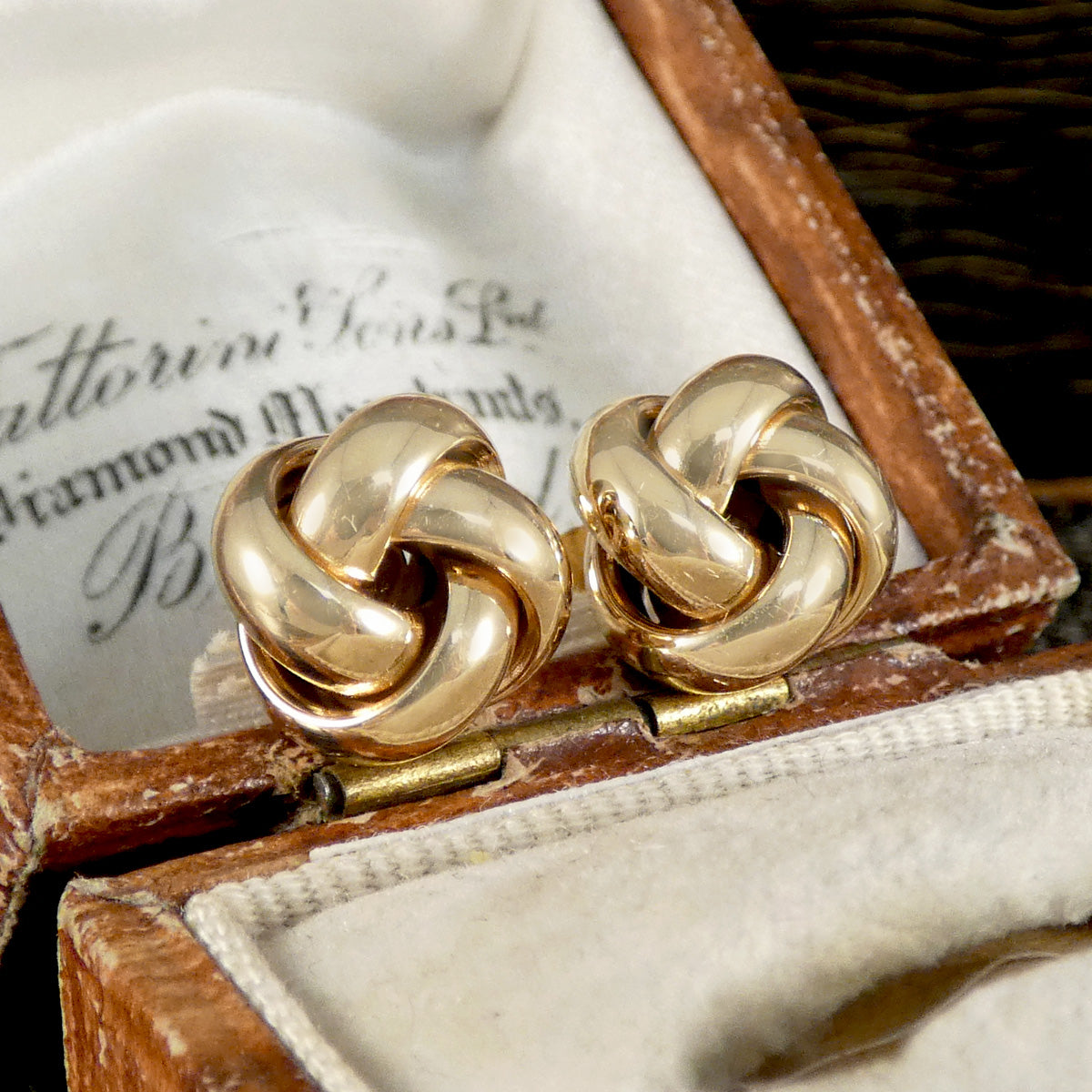 A pair of knot stud earrings in 9ct yellow gold displayed in a vintage box
