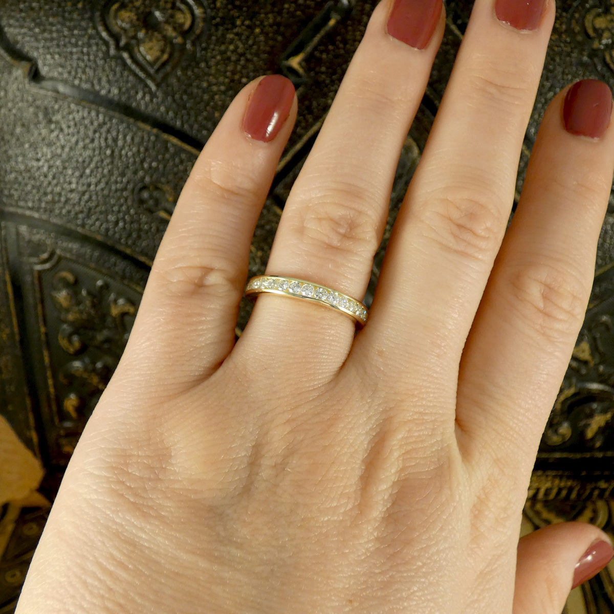 Channel Set 0.54ct Brilliant Cut Diamond Half Eternity Ring modelled in 9ct yellow gold for durability. Showing on hand to se size reference.