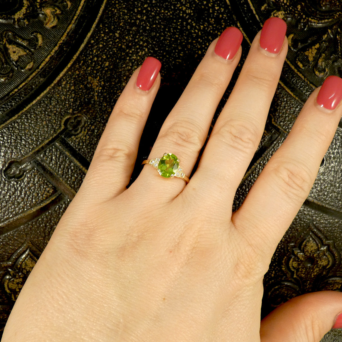 Peridot and Diamond ring on the hand to show the size proportion on the hand when worn.