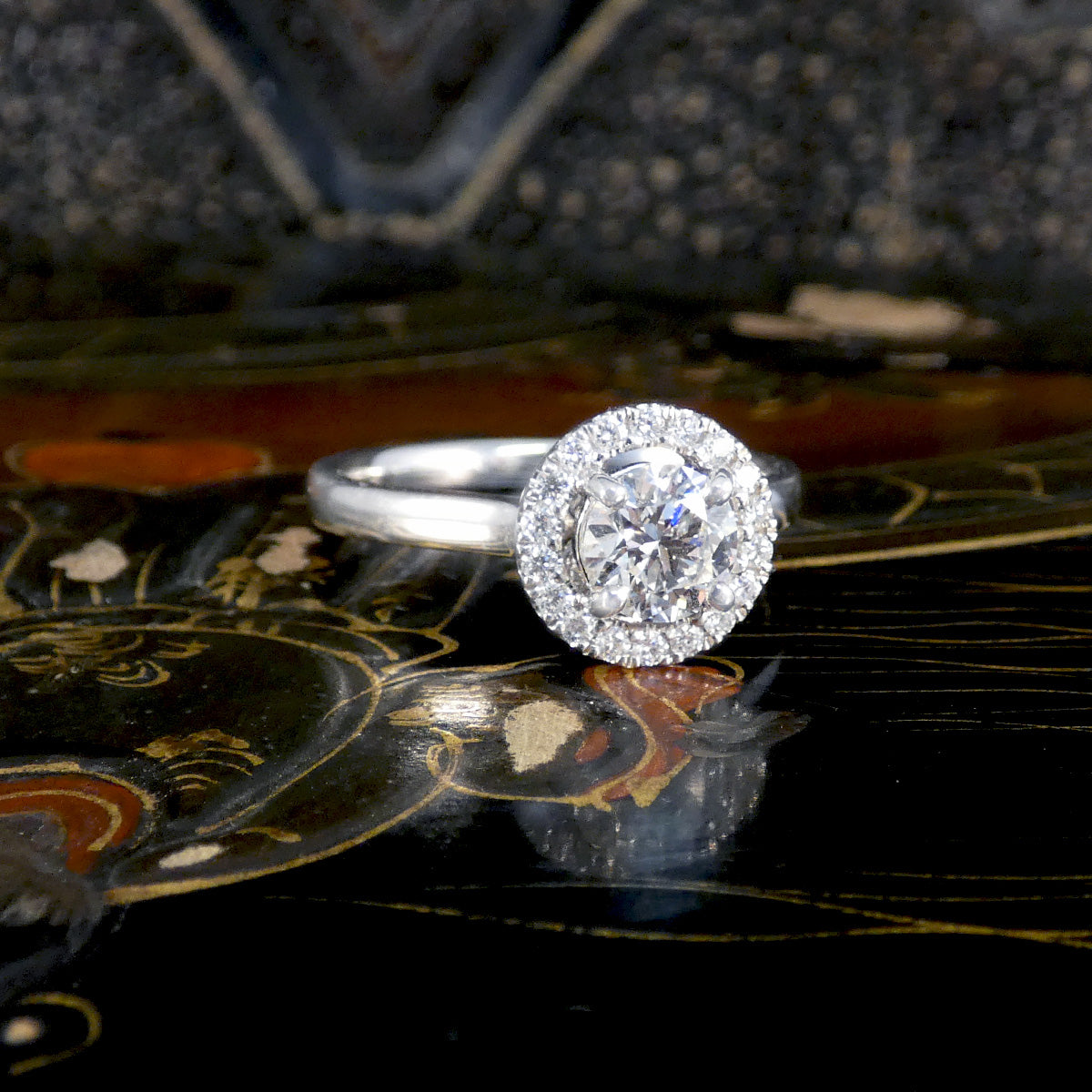 A diamond halo cluster ring with GIA certed centre stone with high colour and clarity in platinum.