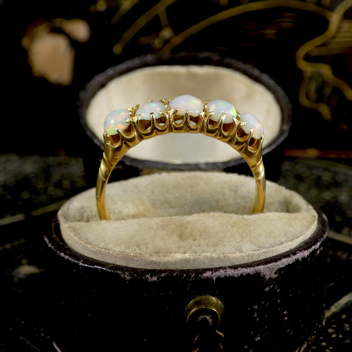 Gold ring with opal stones in a jewelry box