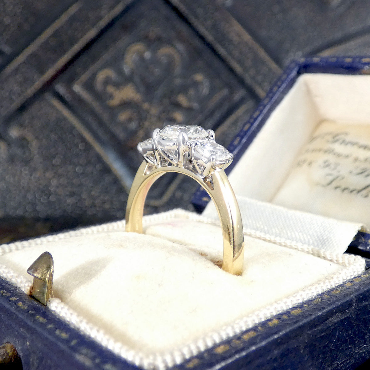 Diamond ring showing wedift design in a blue jewellery box with a white interior