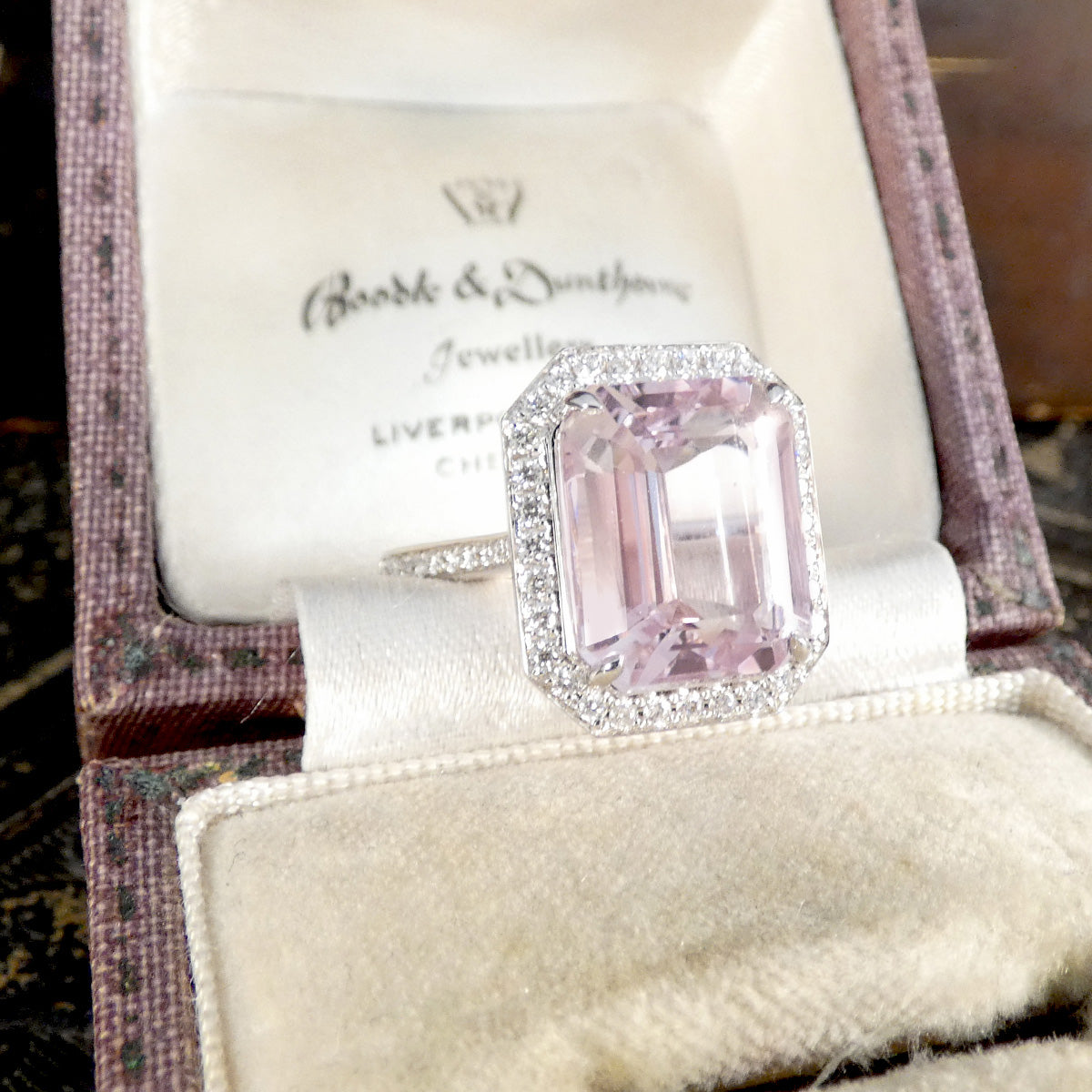 Pink gemstone ring in a vintage ring box