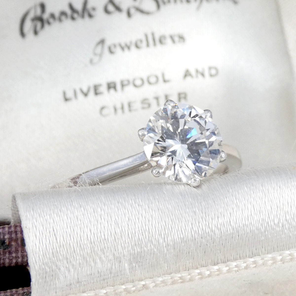 A beautiful classic diamond solitaire engagement ring in platinum. Displayed in a vintage box.