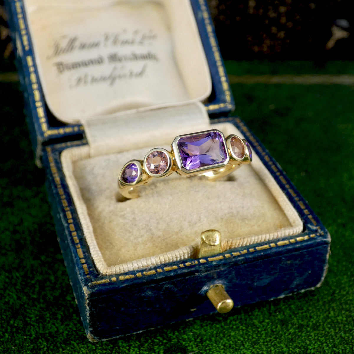 A gorgeous bright and beautiful Amethyst and Pink Tourmaline five stone ring in 9ct yellow gold with bezel settings. Displayed in vintage box.