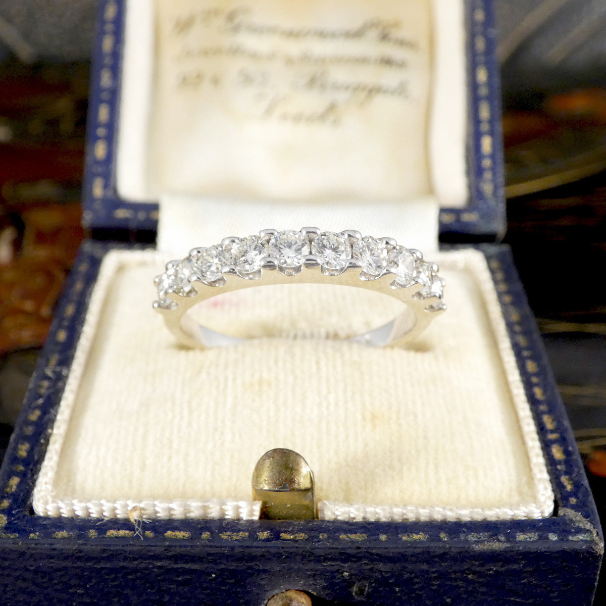 Diamond ring in a blue jewelry box with a blurred background
