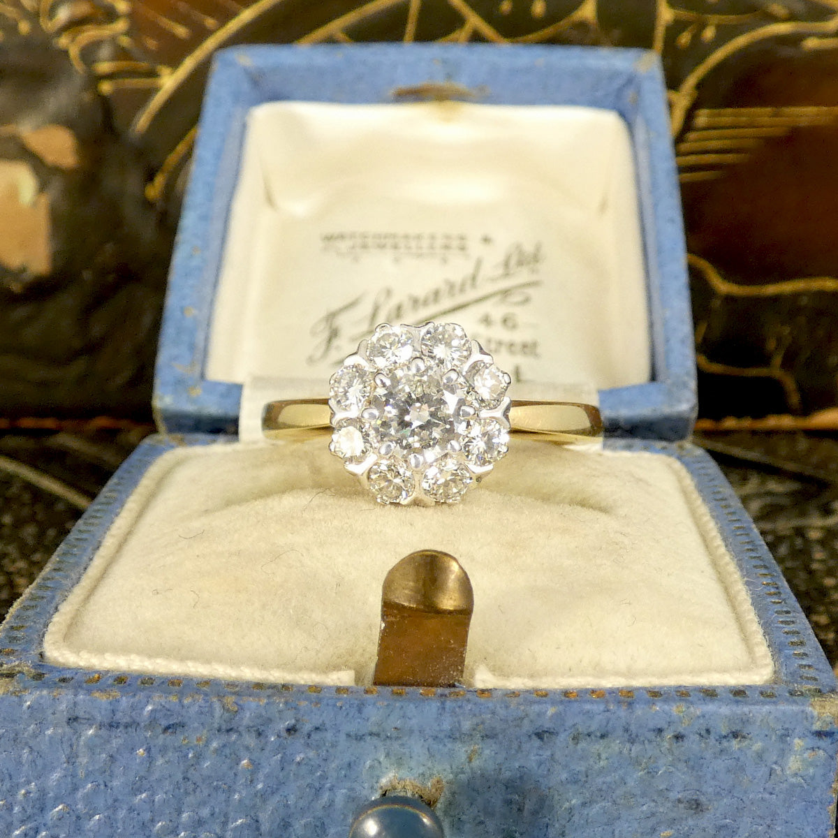 Bright and sparkly vintage early brilliant cut diamond cluster ring in 18ct White Gold with a 18ct Yellow Gold band with slightly tapered shoulders. Holding 0.90ct diamonds and the perfect gift or engagement ring idea for vintage lovers. Shown in vintage box.