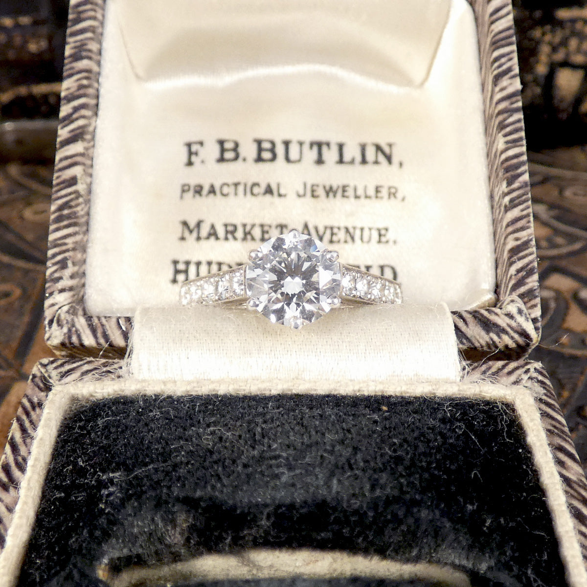 1.30ct Diamond Solitaire with 0.56ct Diamond Set Shoulders in Platinum. High clarity and and near colourless grading, the perfect engagement ring. Displayed in vintage box.