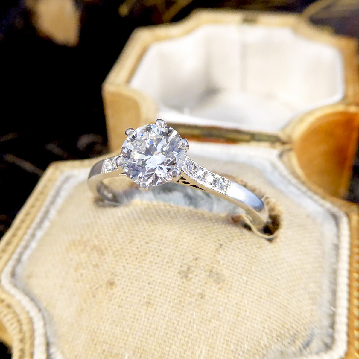 Diamond ring in an open jewellery box with a blurred background