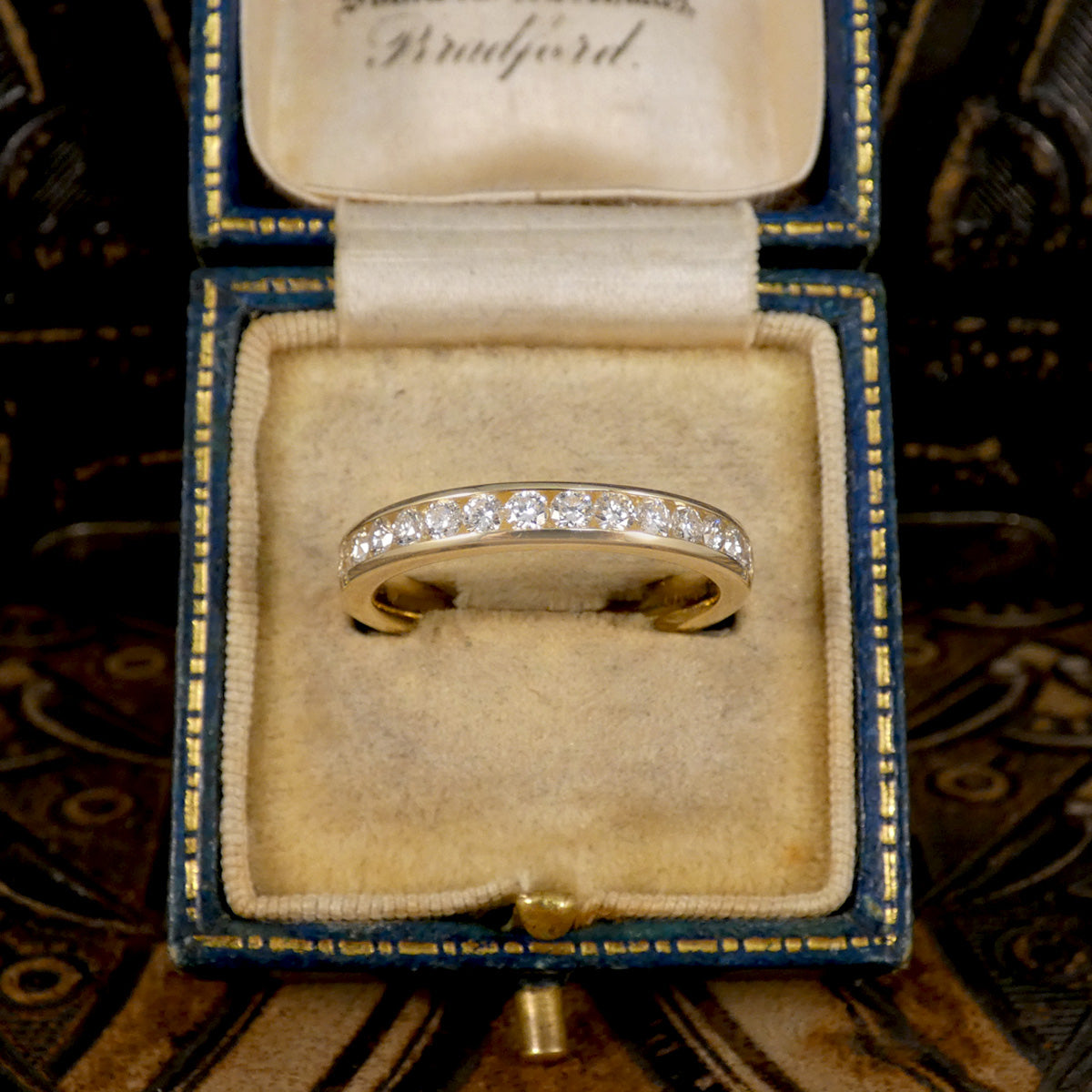Channel Set 0.54ct Brilliant Cut Diamond Half Eternity Ring modelled in 9ct yellow gold for durability. Bright and clear diamond displayed in vintage box.