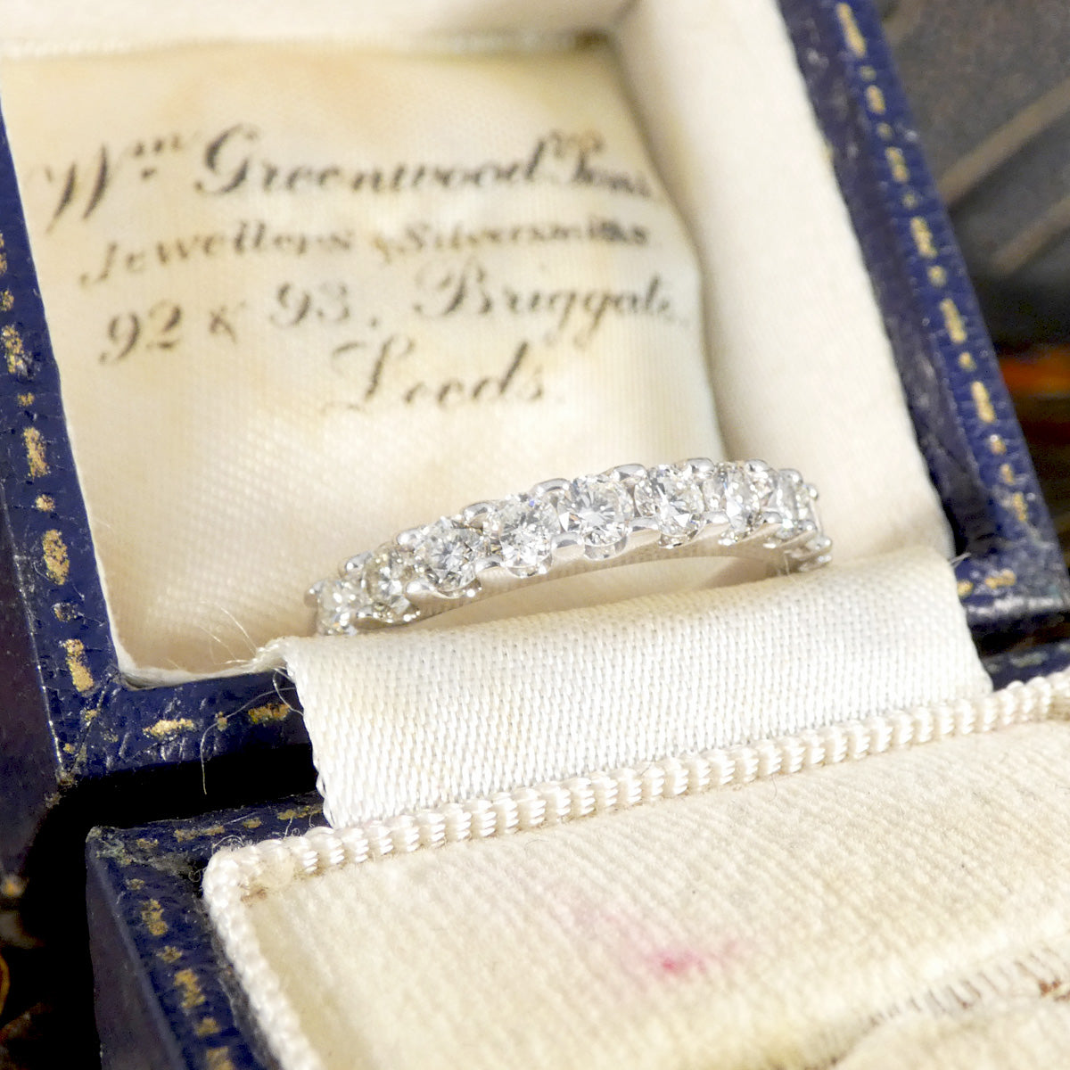 Diamond ring in a jewelry box with visible branding